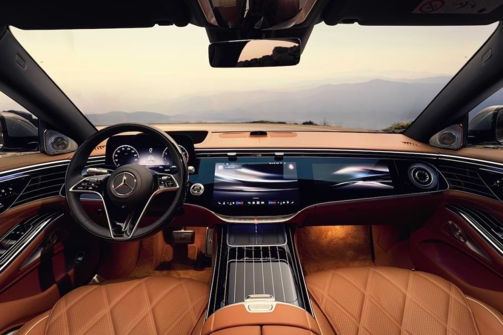 Front interior of the Mercedes-Maybach S-Class featuring digital displays, refined dashboard design and ambient lighting