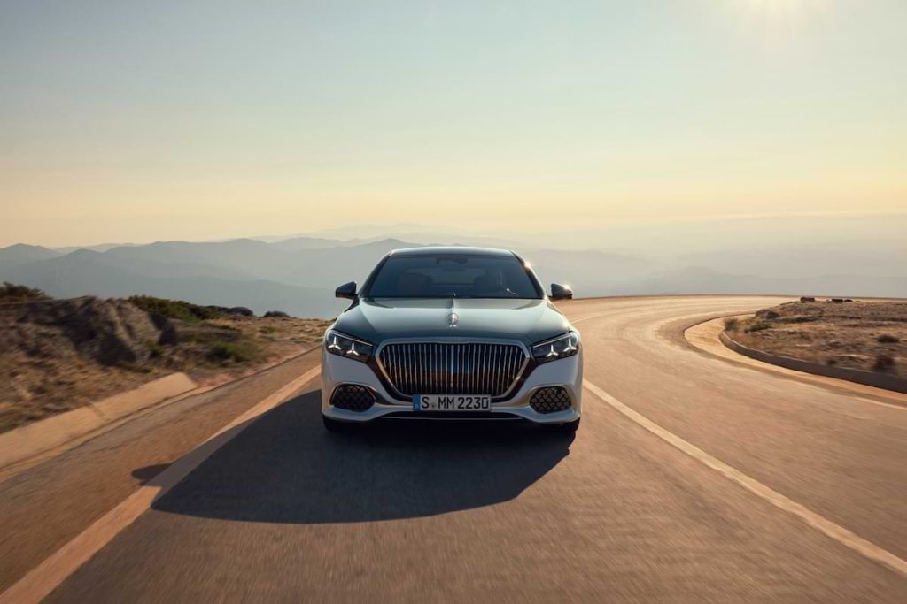 Mercedes-Maybach S-Class 2026 front view driving on a scenic road highlighting luxury design and premium exterior styling