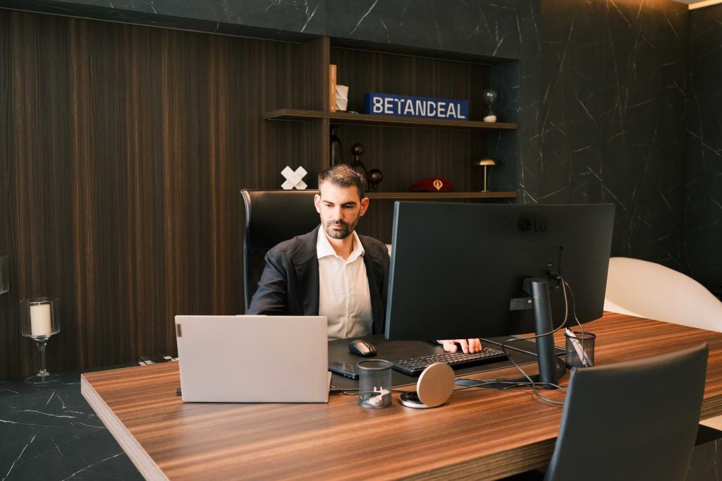 Joaquín Gago, CEO of Betandeal, working at his desk in a modern office environment